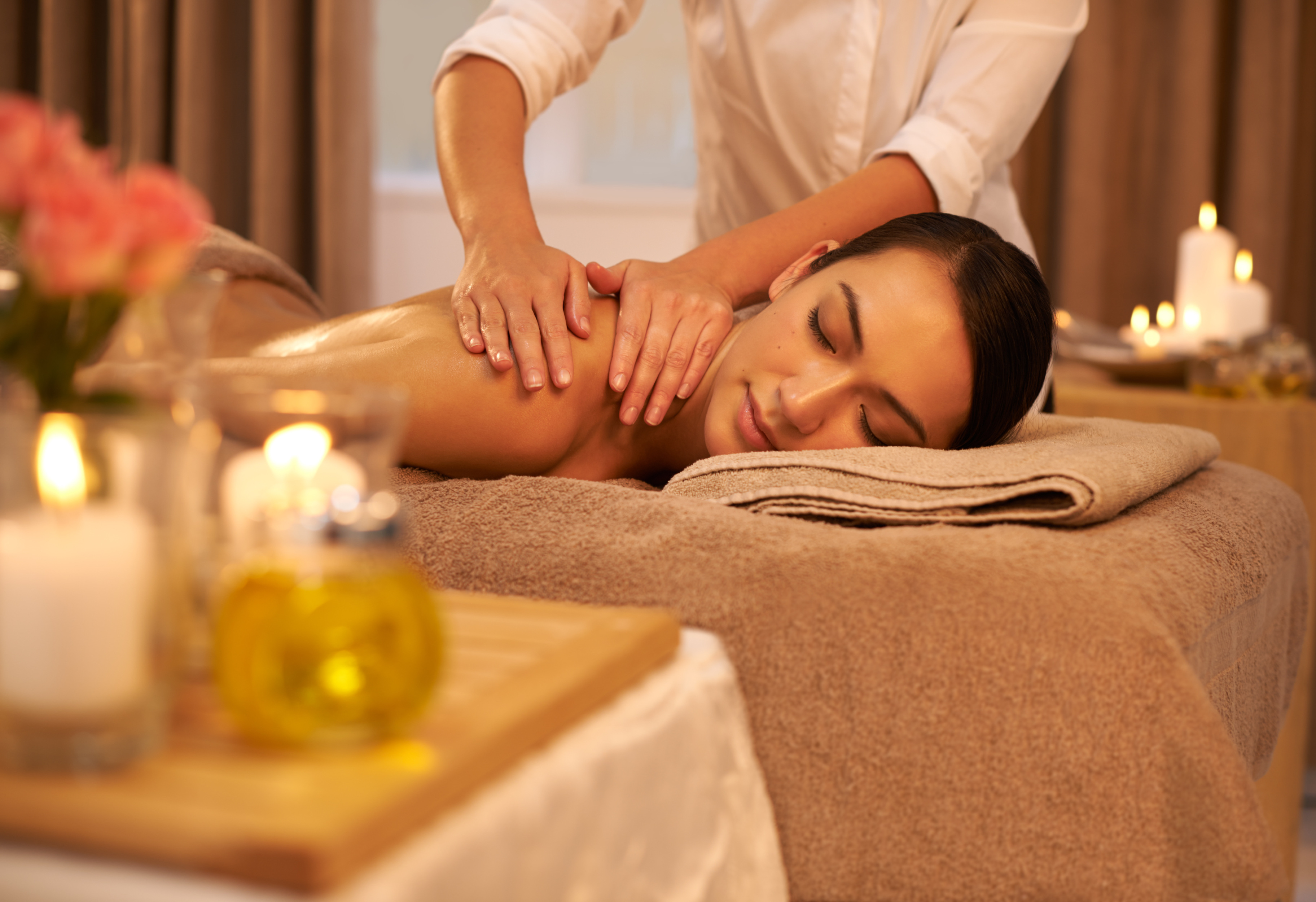Relax, back massage and female person at salon, treatment and wellness for holistic care. Calm, peace and muscle tension relief with reflexology from therapist, beauty spa and masseur for body health.